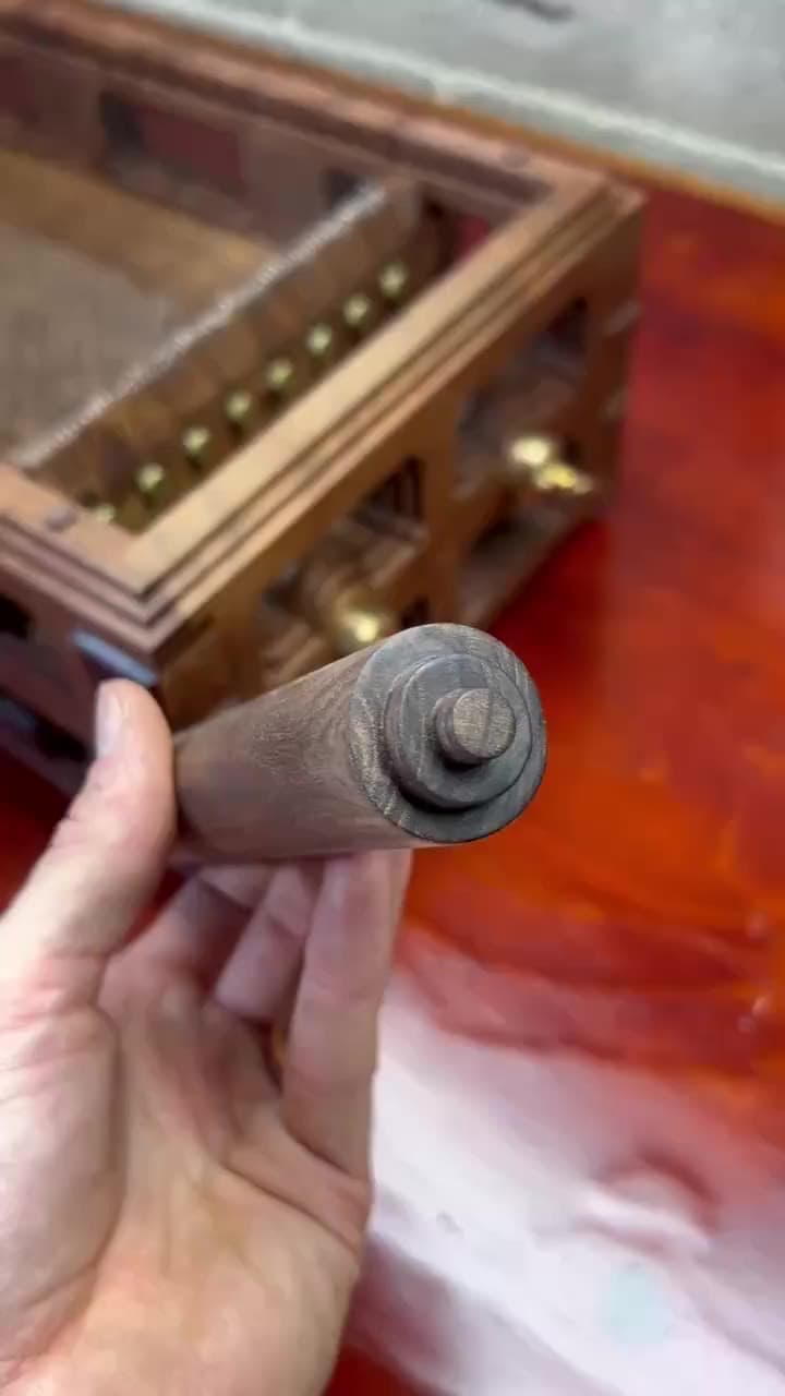 The walnut roller run across the chitarra's strings
