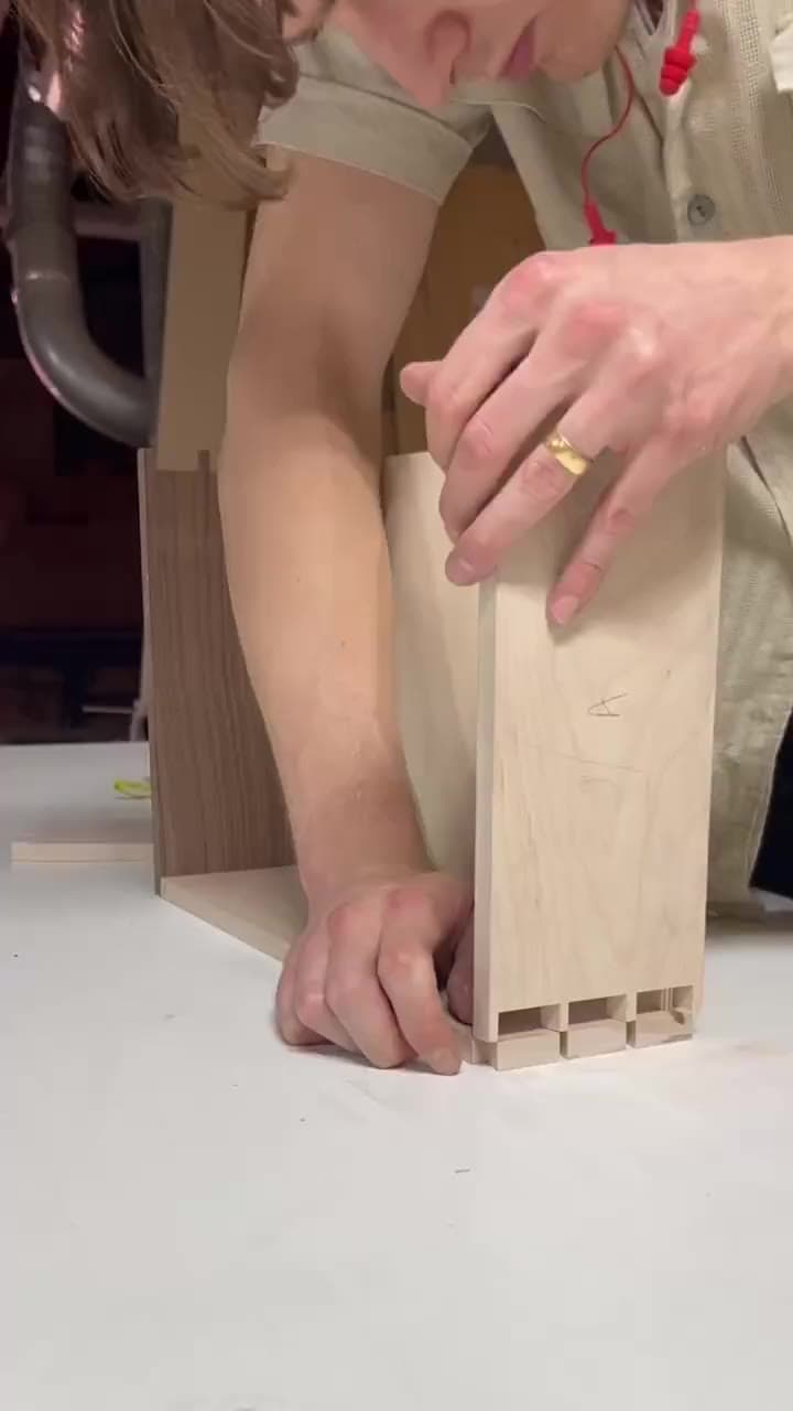 A hand-dovetailed maple drawer being assembled and fitted