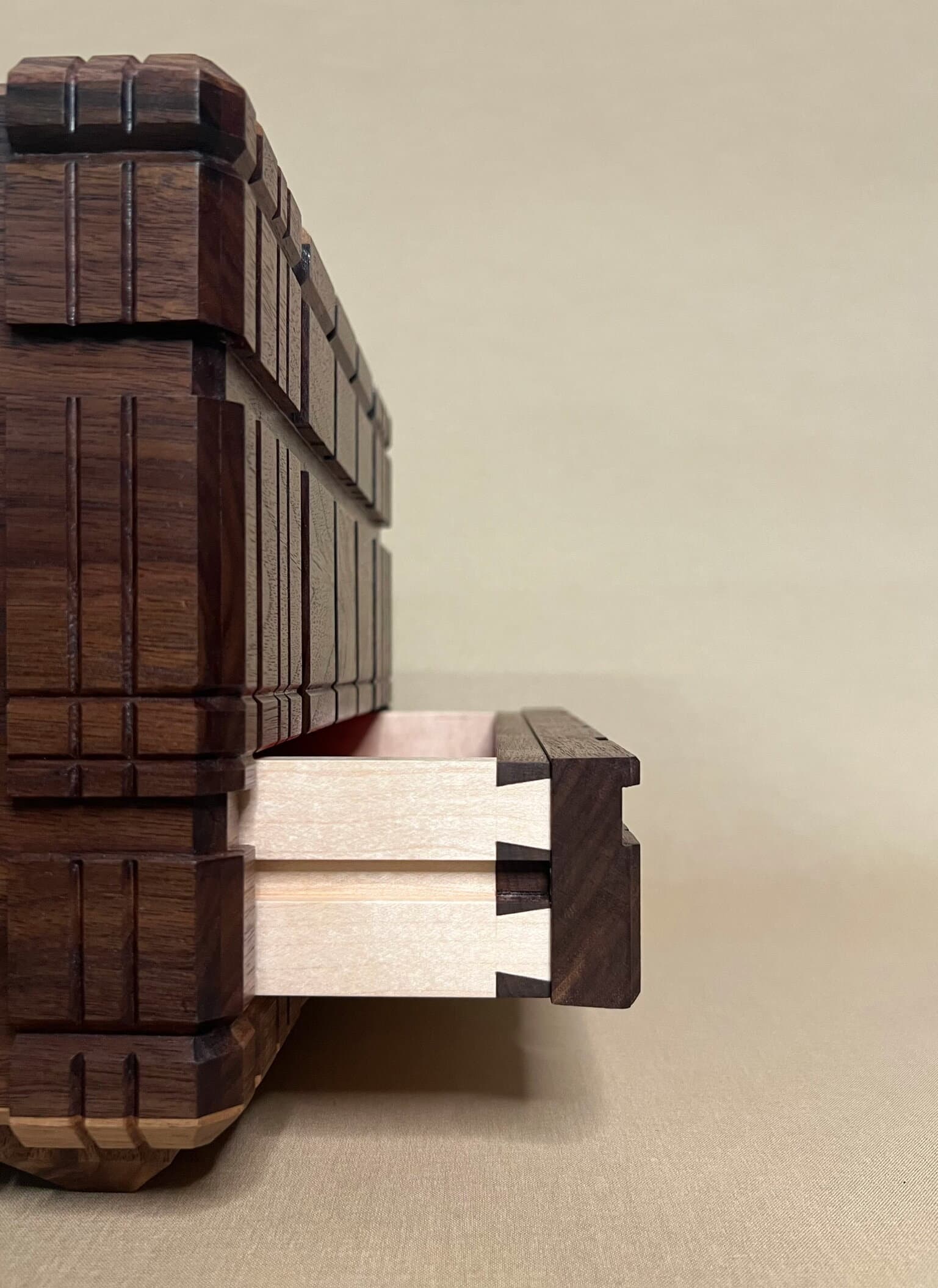 The puzzle box side on, a dovetailed maple drawer pulled out