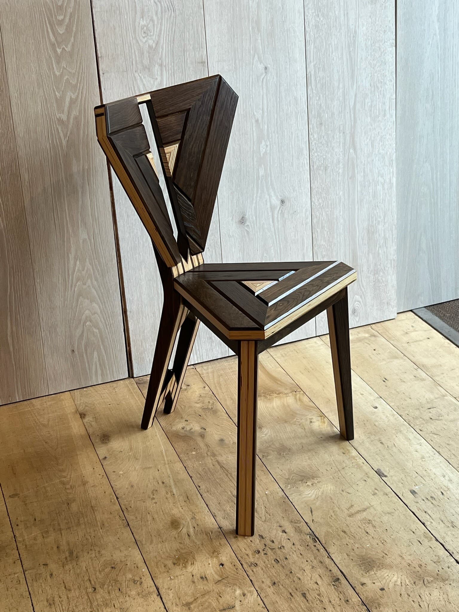 The Tate chair from the front, a triangular seat under a kite-shaped back