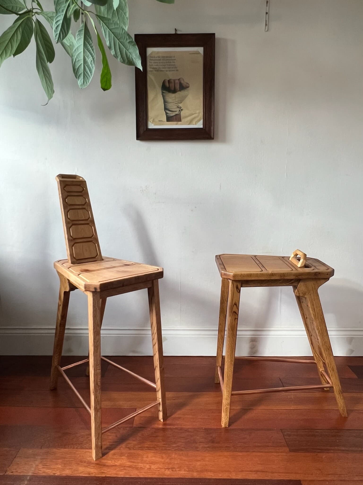 Two stools side by side, one with its backrest raised