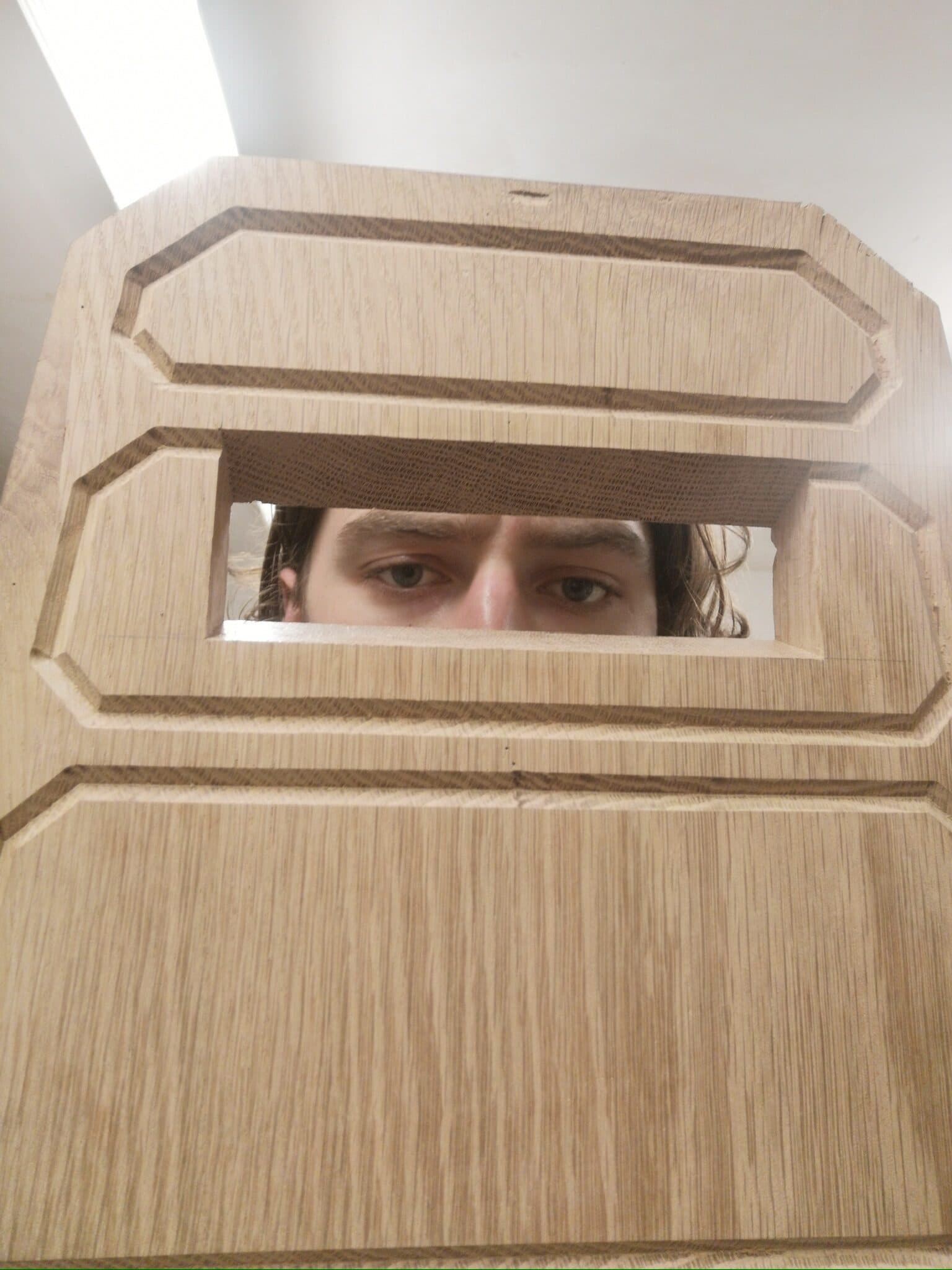 Looking through the handle cut into the backrest's carved panels