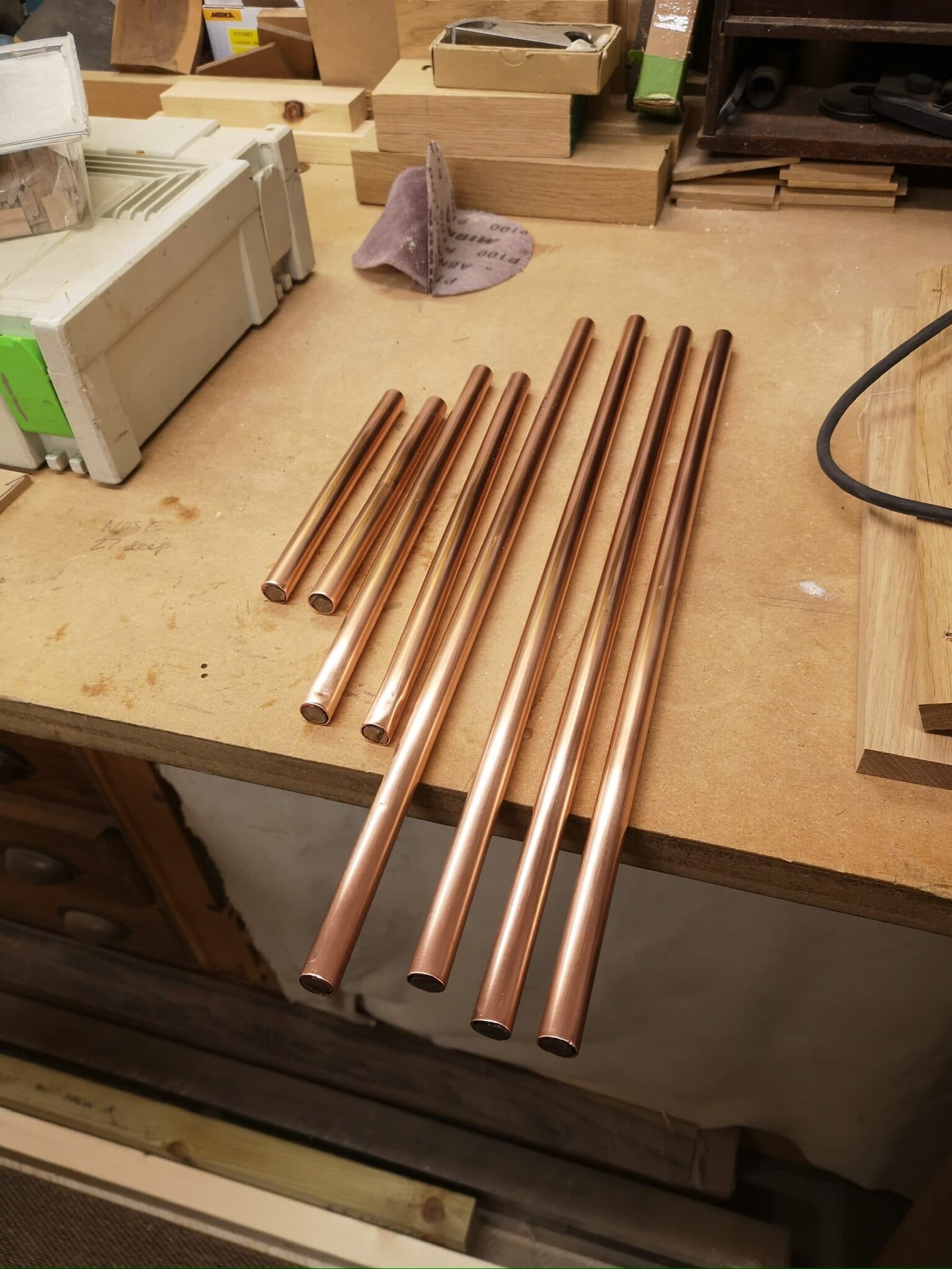 The stretchers cleaned back to bright copper on the bench