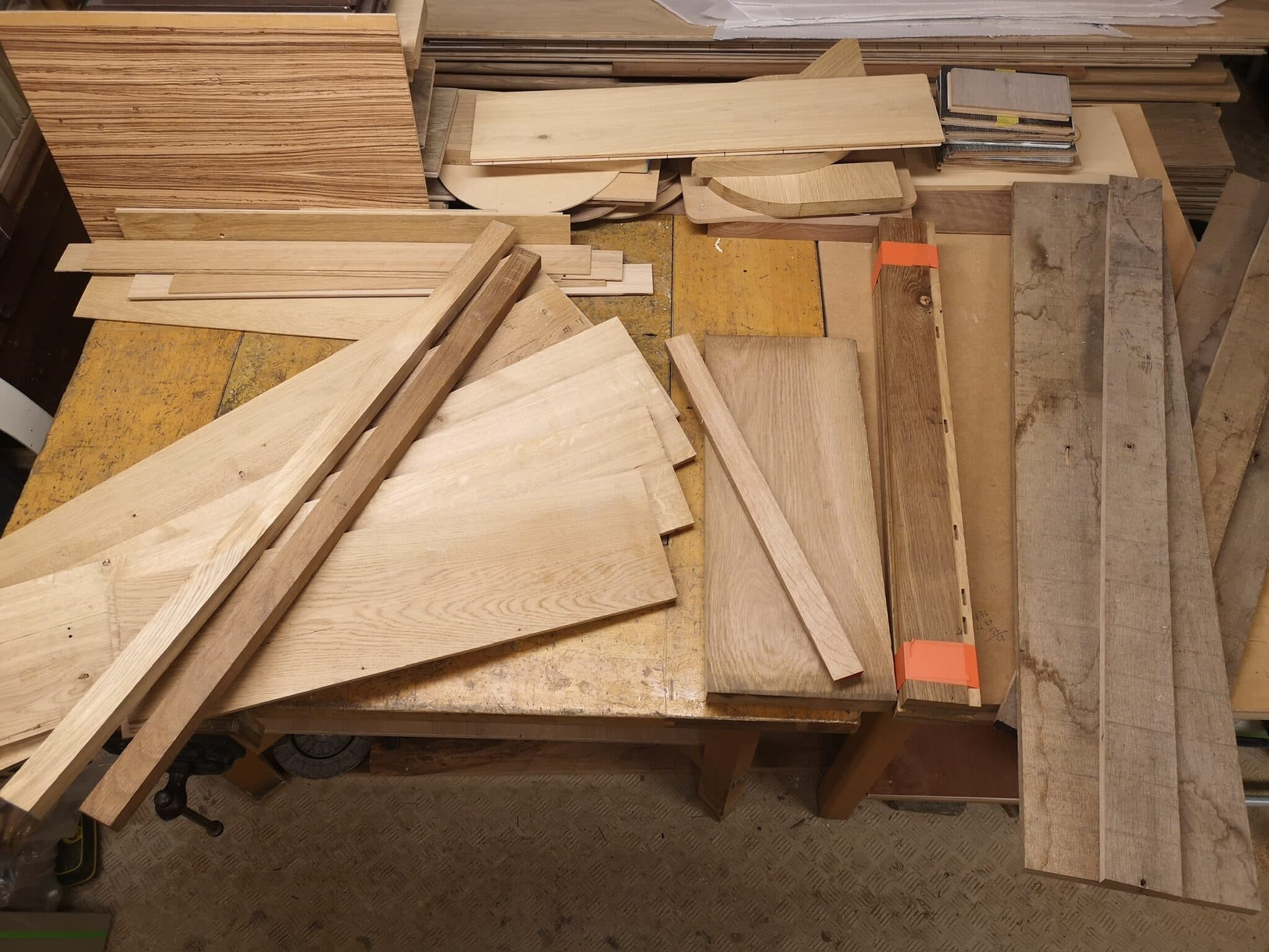 The oak flooring cut down into lengths across the bench